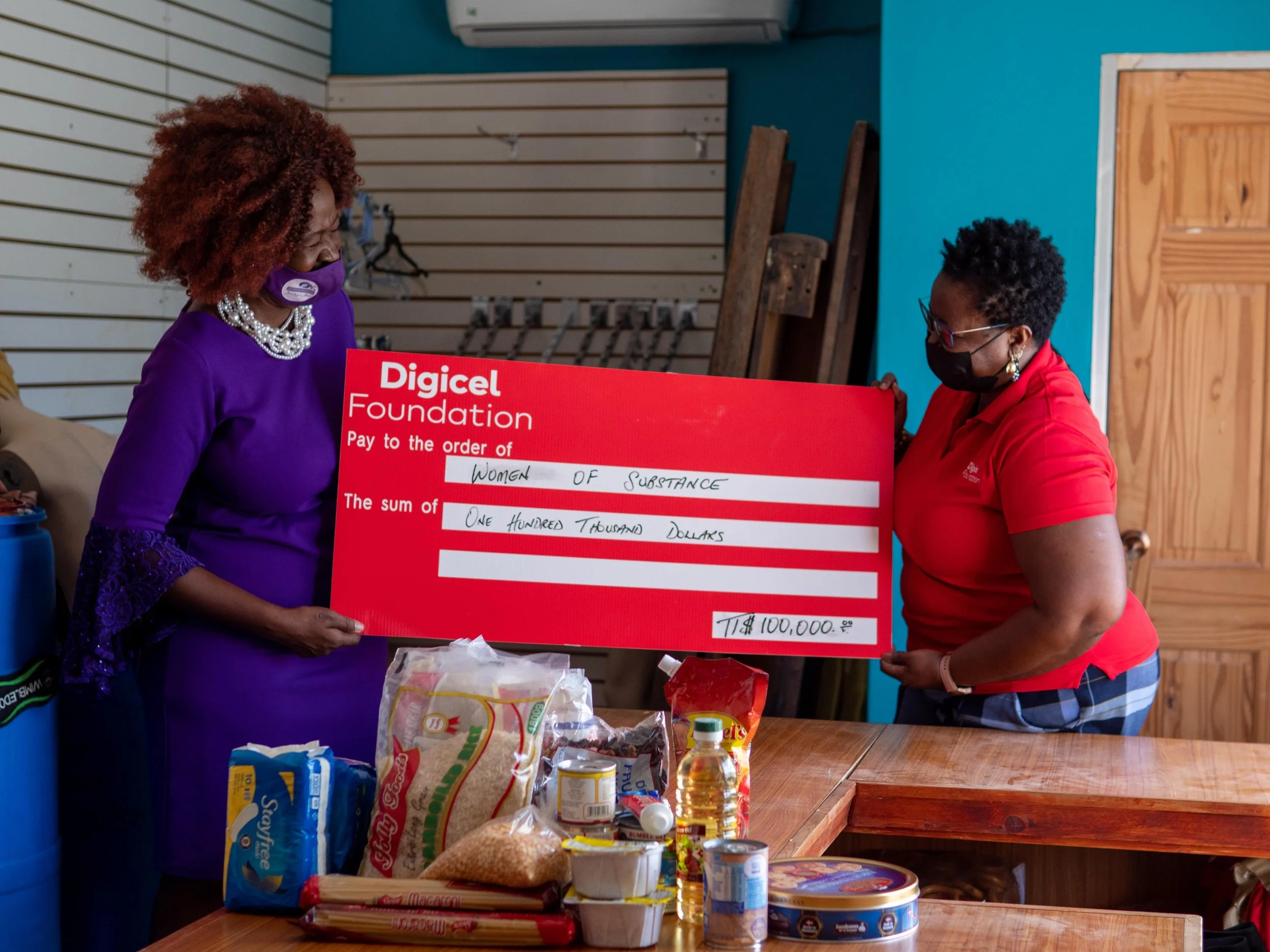 (L-R) Onika Mars, President and Founder of Women of Substance receives the cheque donation of TTD$100,000 from Digicel Foundation Board Director, Georgina Peterkin which will go towards developing- Shangri-La Empowerment Centre for Women, a safe haven for women who are survivors of domestic violence.
