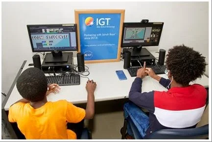 Two of the young boys from Jairah Boys’ (Raffa House) are excited to engage in the learning activities of the IGT Coding and Robotics Rock Camp.