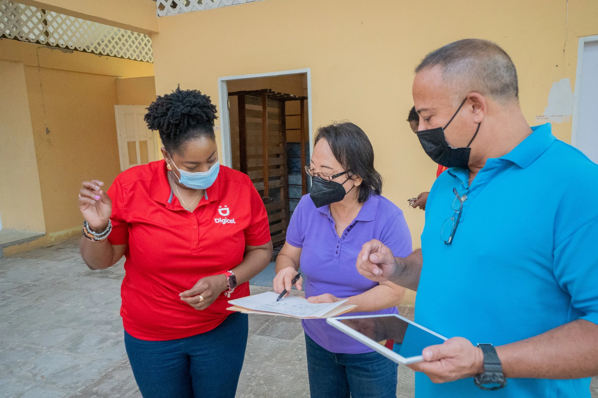 One of the contractors, Russel Aching (right) explains an architectural layout to Mizpeh Halfway House Founder, Reverend Pearl Noreiga (left)