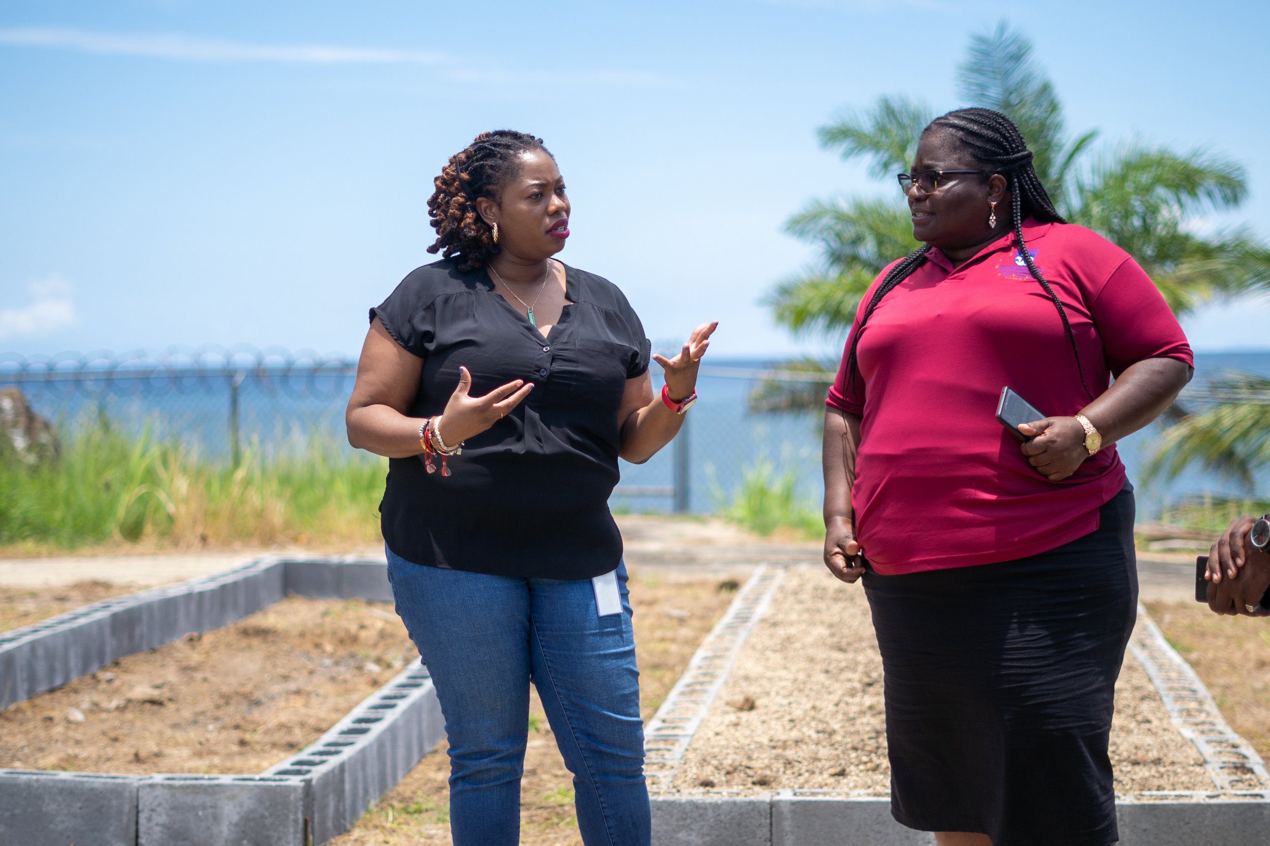 Leader of the La Brea Police Youth Club Woman Corporal Jasmine Vesprey-David and Digicel Foundation Operation Manager- Cindy ann Currency discuss details, updates and logistics for the agricultural project.