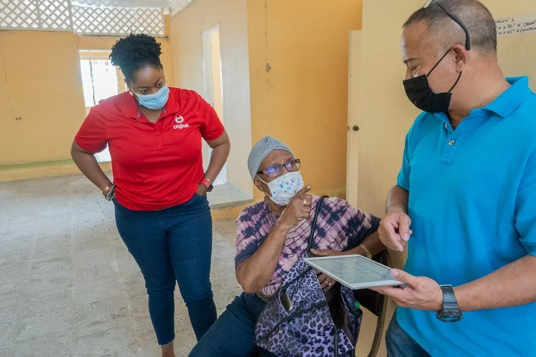 Mizpeh Halfway House Founder, Reverend Pearl Noreiga (centre) chats with one of the contractors, Russel Aching (right) while Digicel Foundation Operations Manager, Cindy Ann Currency (left) looks on.