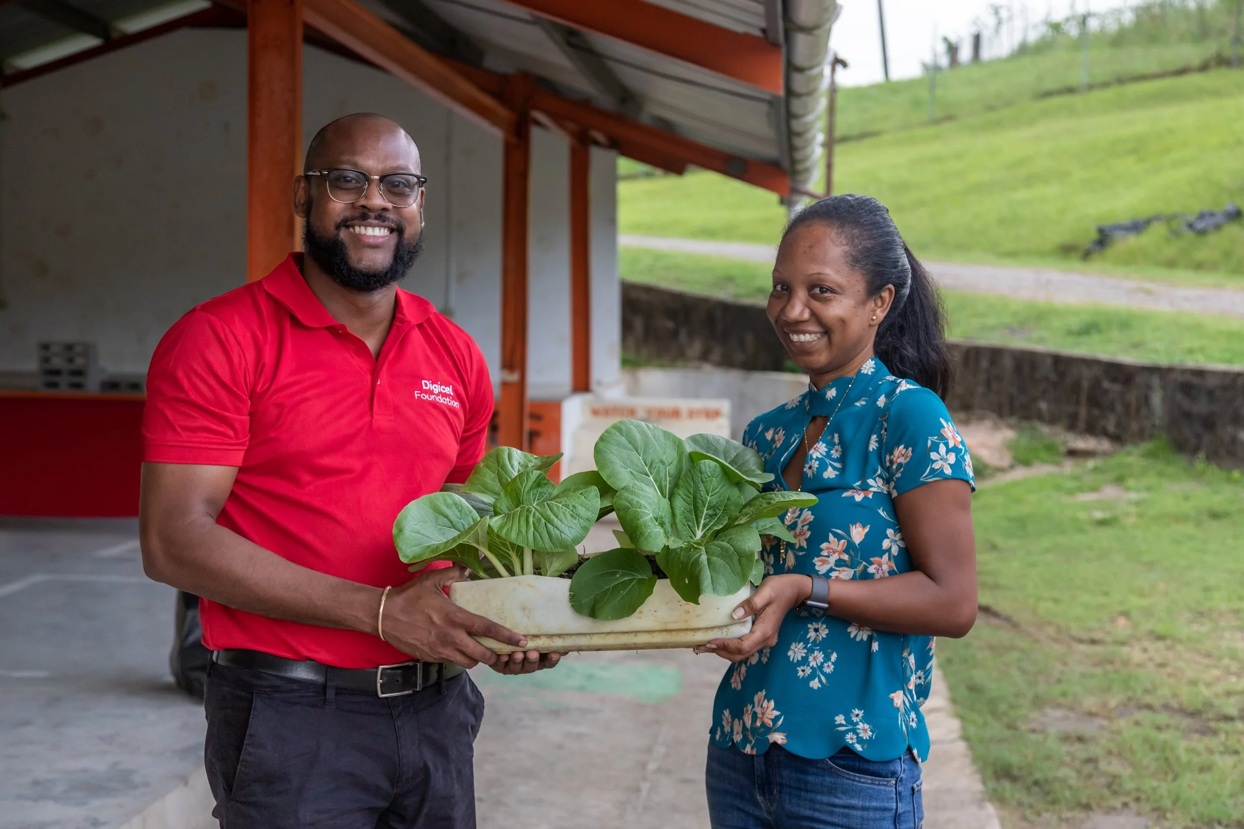 (L-R) Digicel Foundation Board Member – Jerren Lewis and The Moruga 2050 Association for Sustainability Secretary - Kerneil Mitchell display one of the plants.