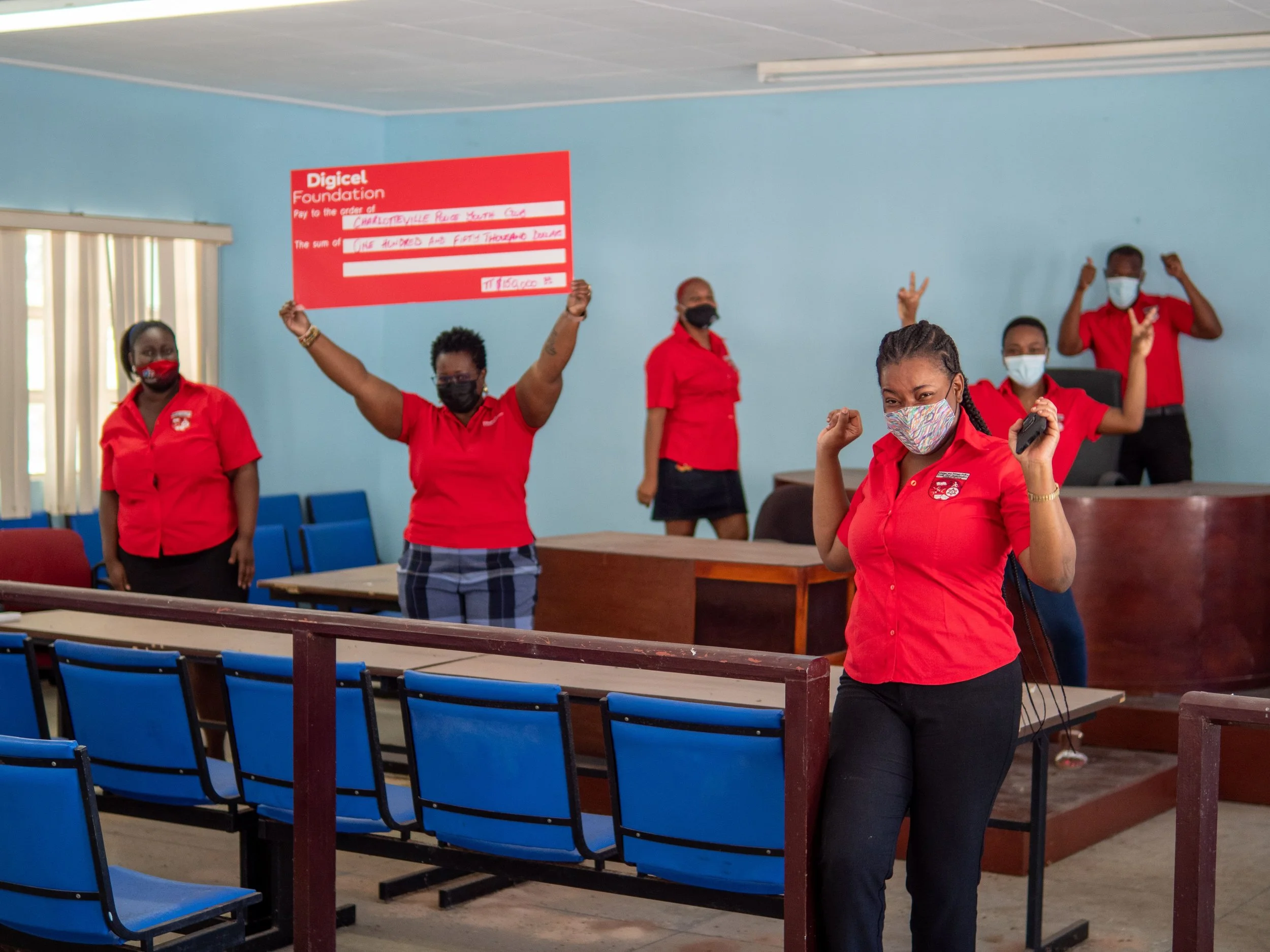 Digicel Foundation Board Director, Georgina Peterkin displays the cheque donation of TTD$150,000 given to the The Charlotteville Police Youth Club. The funding will go towards development of its Youth Skills Centre.