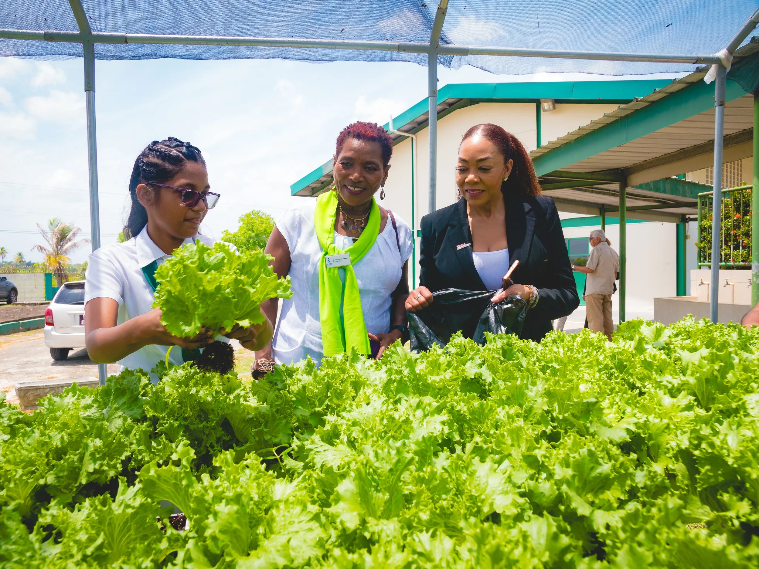 Digicel Foundation CEO Penny Gomez (right) with Gemma Casimir Redman, President of Soroptimist International Esperance, and ASJA student Anisha Casimir Redman at the launch of the hydroponic greenhouse at ASJA Girls College Barrackpore on 17 April 2024.