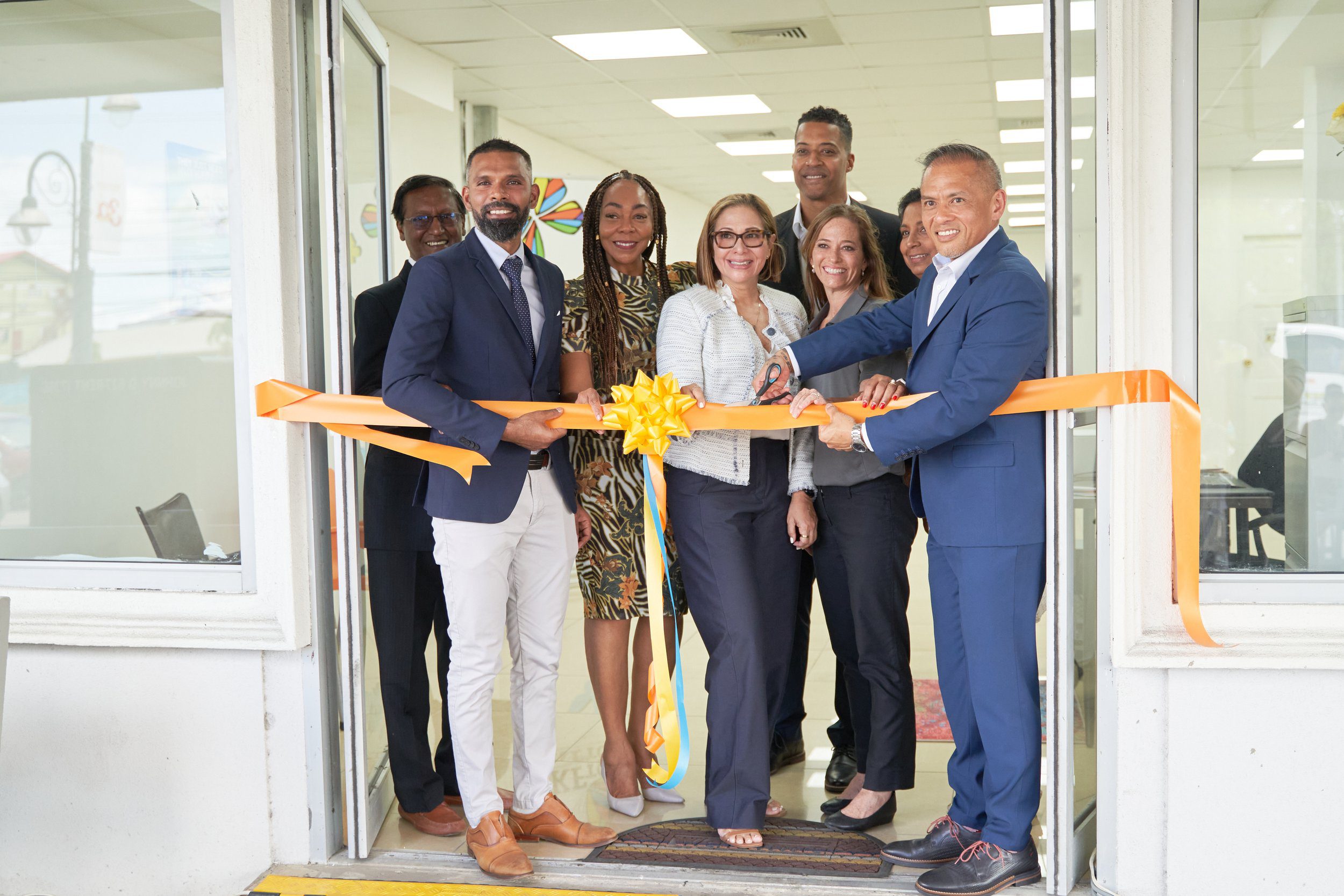 CKFTO Chairman Derek Luk Pat (far right) cuts the ribbon to open the new clinic on Ramsaran Street, Chaguanas. He is joined by, from left, Vishnu Charran, Director of the Chamber of Commerce and Industry for Chaguanas; His Worship Faaiq Mohammed, Mayor of Chaguanas; Penny Gomez, CEO of the Digicel Foundation; and CKFTO's Vice-Chairman Sofia Figueroa-Leon, Secretary Nicholas Pena, General Manager Krista Hamel-Smith and Director Sarah Ramcharitar.