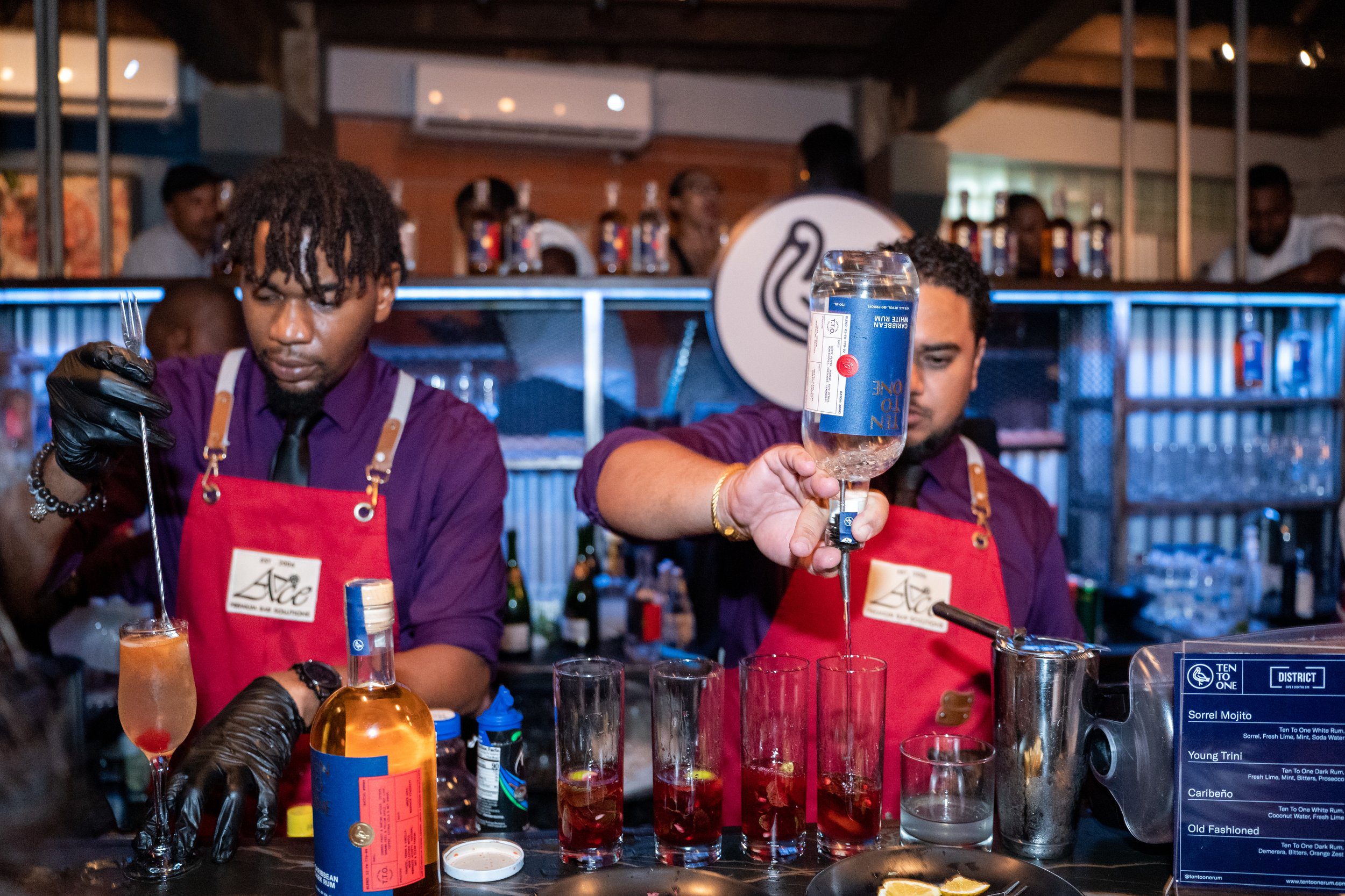 Bartenders create signature cocktails with Ten to One rum at a recent event at District Cafe in Woodbrook.