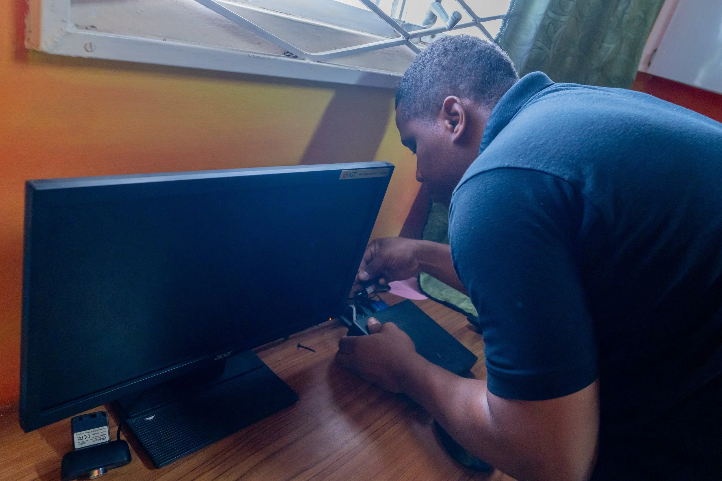 Deshawn Bruce, IGT’s Repair Technician, inspects the equipment at Amica House during IGT’s Global Giving Month in May 2024.