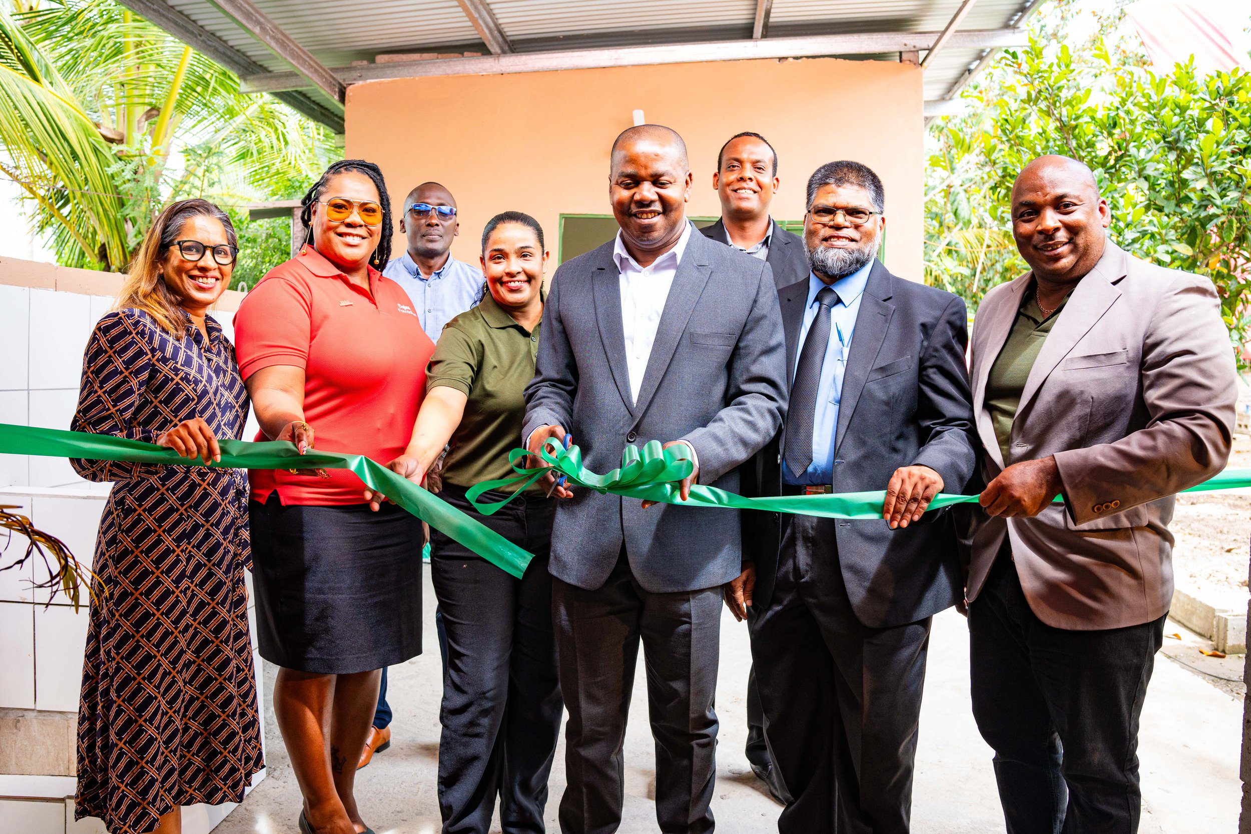 (L-R) Gina Ramcharan, Environmental and Assurance Lead, Shell T&T; La Toya Gopaul, Digicel Foundation Director; Guy Small, Digicel Foundation Director; Alana Seemungal, Vice President, Brazil Village Farmers Group; The Hon. Foster Cummings, MP for La Horquetta/Talparo Constituency; Ruel Guerra, Executive Member of Brazil Village Farmers Group; Farook Hosein, PS in the Min. of Agriculture, Land and Fisheries; and Randell Patterson, President of the Brazil Village Farmers Group cut the ribbon to the new Agro Processing and Packaging Facility on Brazil Lome Trace on Wednesday 21 February 2024.