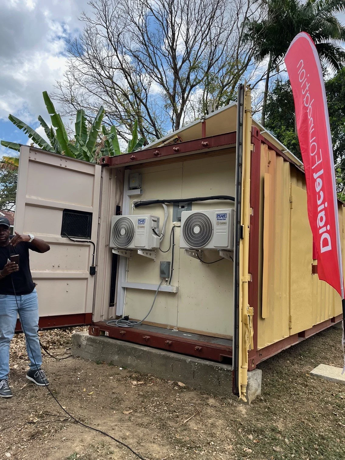 Adrian Thomas of ReNewTT displays the solar powered advantages of the newly unveiled Climate Smart Cocoa Storage facility on March 27th, 2024.