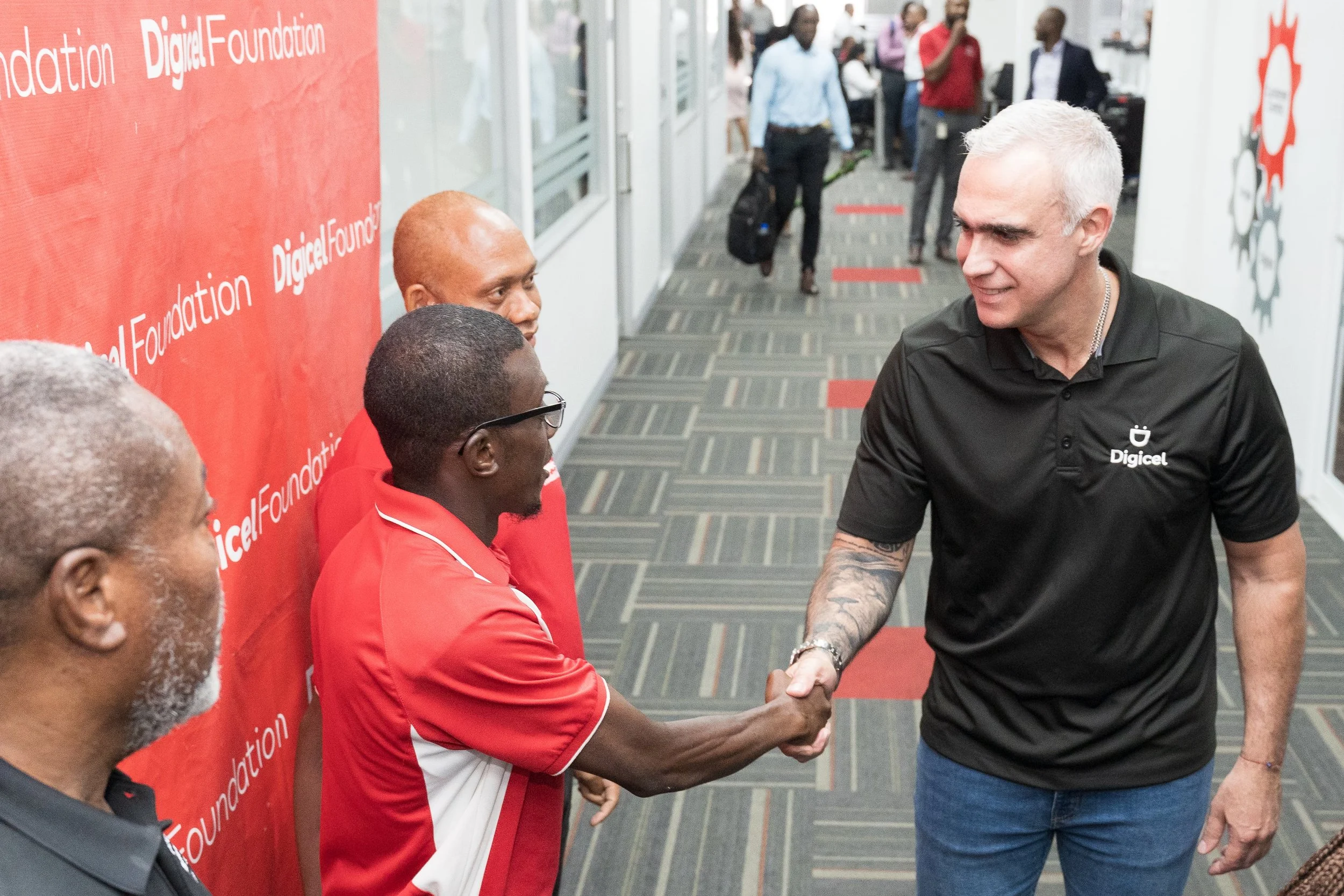 Digicel Group CEO Marcelo Cataldo (on the right) shakes hands with athlete Justin Providence, who will represent TT in the first-ever Special Olympics Caribbean Beach Games in November 2024.