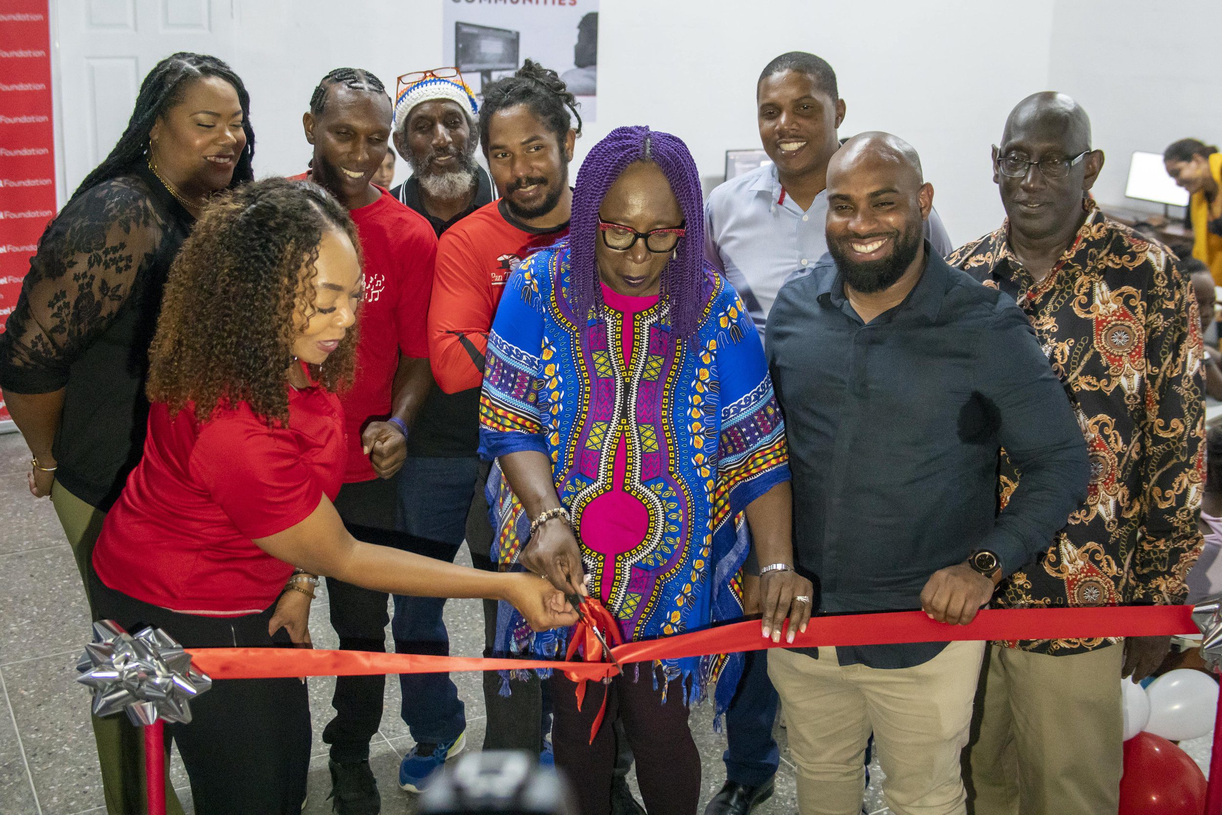 (Front L-R) Penny Gomez, CEO of the Digicel Foundation, Beverley Ramsey-Moore, President of PanTrinbago and Councillor Josiah Austin, Chairman of the Tunapuna Piarco Regional Corporation, cut the ribbon on the Technology in Education Centre at Curepe Scherzando Panyard on Wednesday 6 March 2024, in the company of excited representatives from Curepe Scherzando, T&TEC Tropical Angel Harps, NGC Couva Joylanders and NLCB Fonclaire.