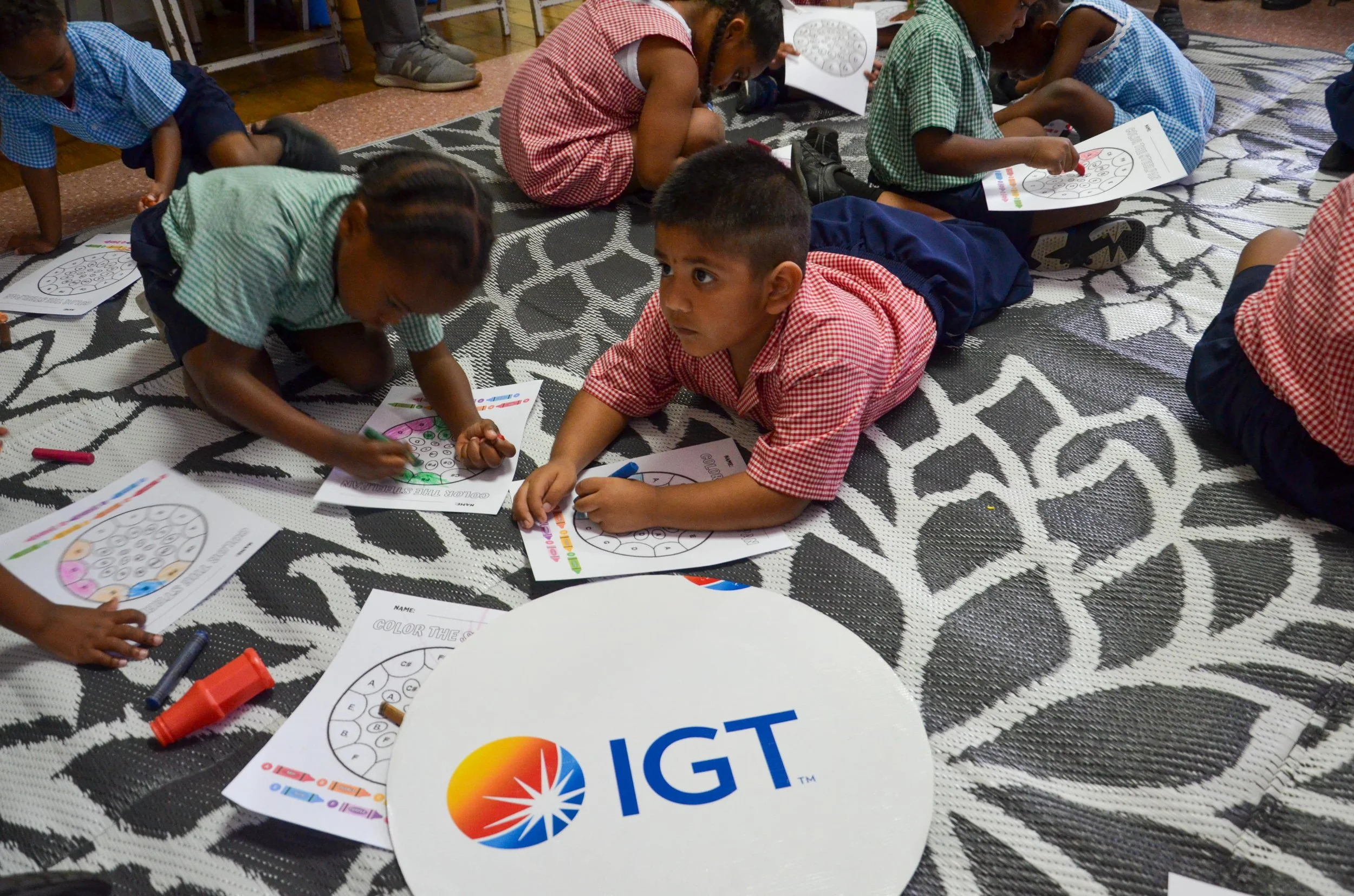 These children explore musical notes through colouring sheets prepared by IGT for the Carnival activities at Cotton Tree Foundation in St. Anns.