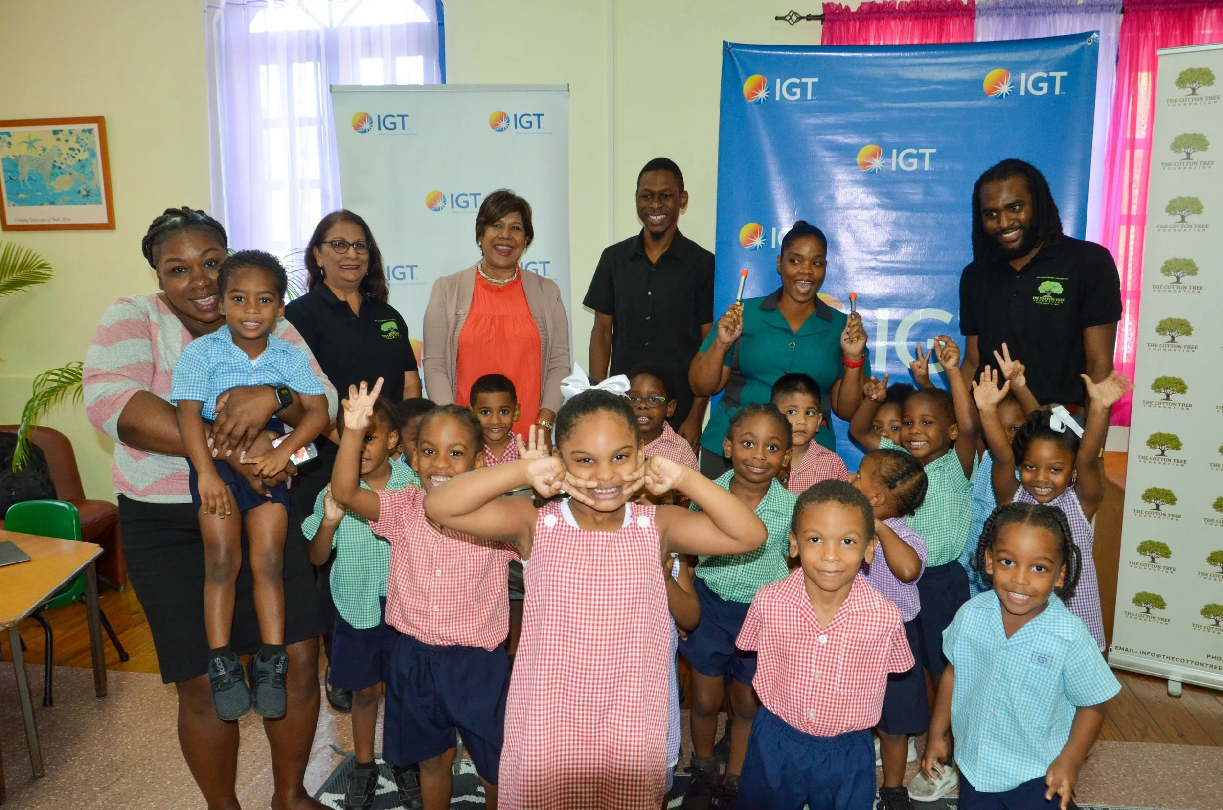 All smiles after a successful morning! Cotton Tree Foundation preschoolers and staff pose for a group photo with IGT P&T Regional Senior Manager for the Caribbean Shavindra Tewarie-Singh.