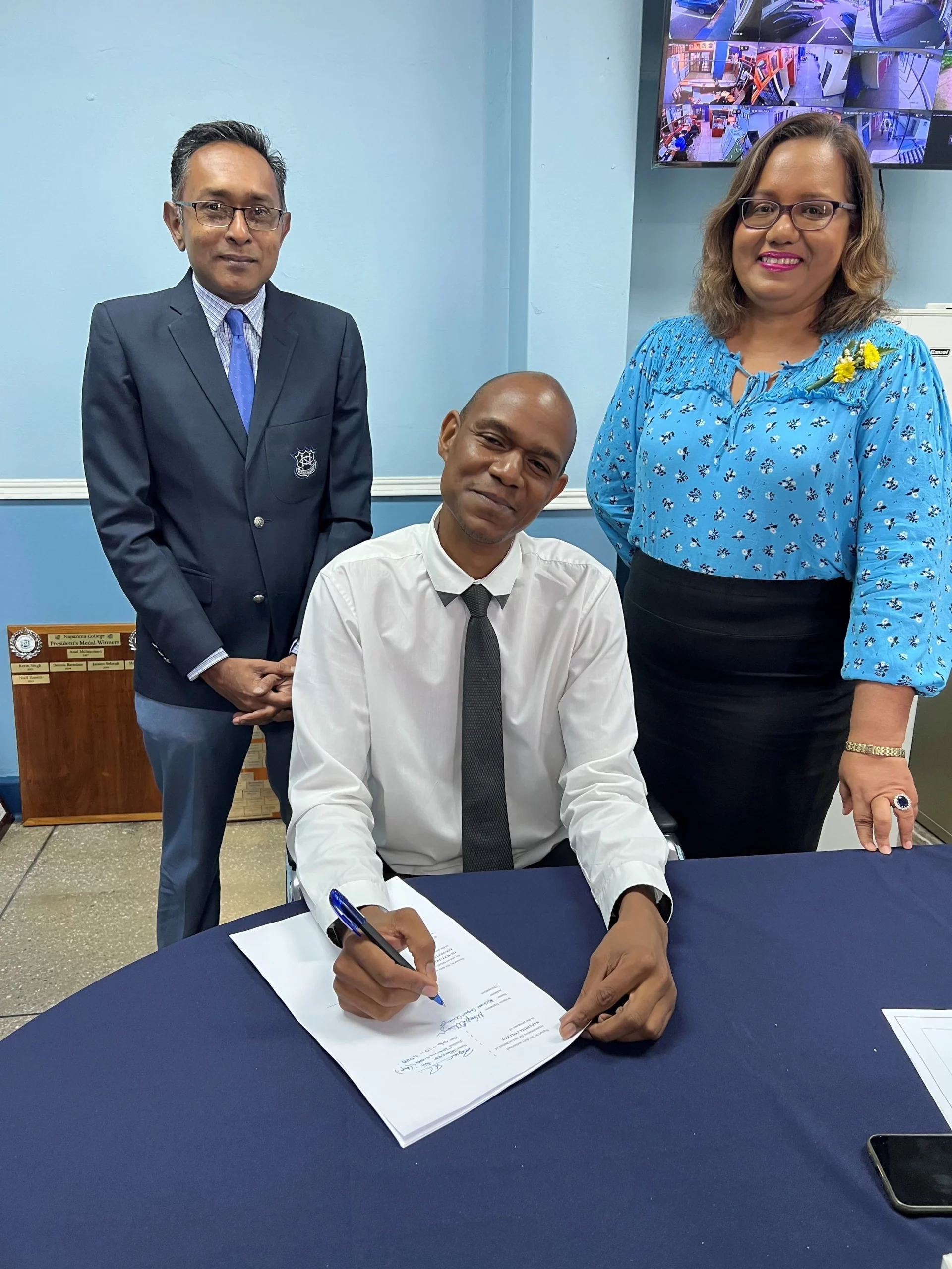 (L-R) Mr. Roger Ali, Naparima College Principal (Ag), Mr. Michael Cooper-Ochiengh and Ms. Hema Jaggernauth, the school’s Communications Manager, at the signing of the 2023 EPIC programme contract.