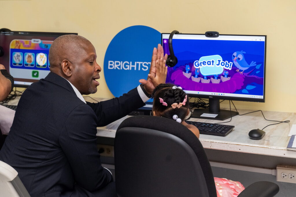 Dexter W. Thomas, General Manager, Brightstar Trinidad and Tobago, gives a young resident of The Living Water Community’s Our Lady of the Wayside Children’s Home a high five.